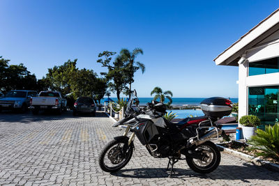 Bicycle parked against blue sky