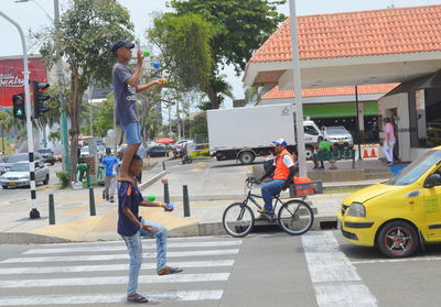 Side view of people on street in city