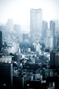 Modern buildings in city against clear sky