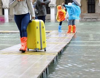 Low section of people walking on road