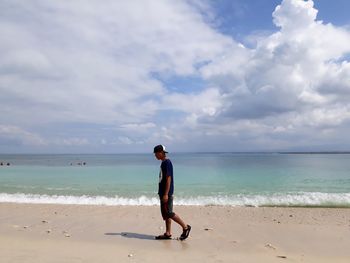 Full length of man on beach against sky