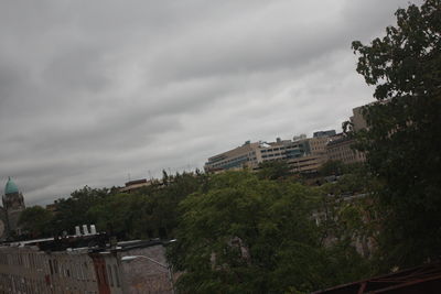 Buildings against cloudy sky