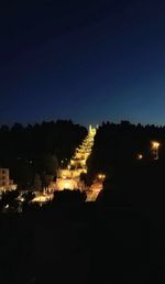 Illuminated buildings against sky at night