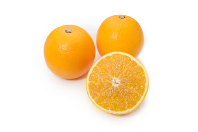 Close-up of orange fruit against white background