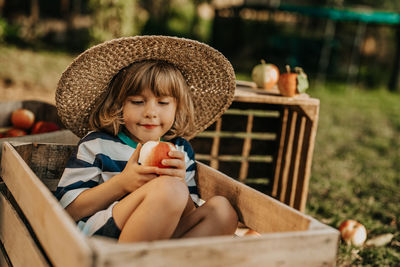 Portrait of young woman sitting in basket