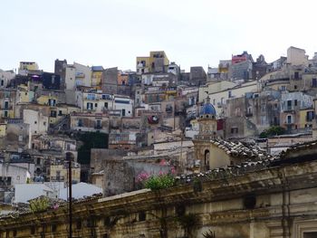 Buildings in city against clear sky