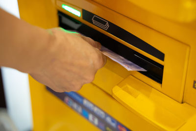 Close-up of hand holding yellow keyboard