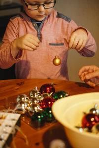 Midsection of boy holding christmas decoration