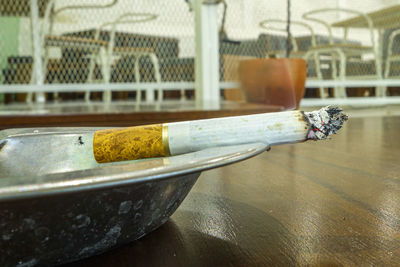 Close-up of cigarette on table