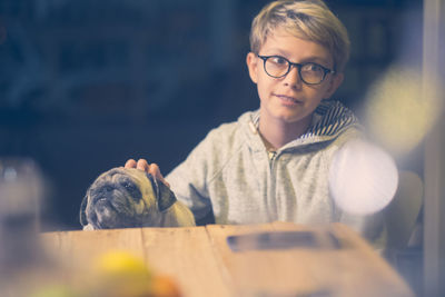 Portrait of boy holding eyeglasses