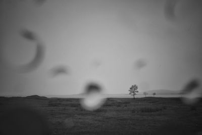 Blurred motion of man on landscape against sky