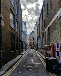 Buildings in city against cloudy sky