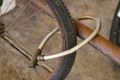 Close-up of bicycle locked on metal