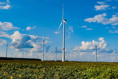 Windmill on field against sky