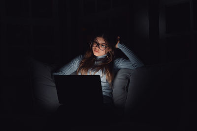 Young woman using laptop at home