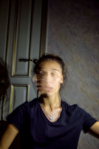 Portrait of young man looking away at home