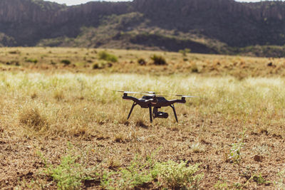 Drone taking off on set of a commercial film shoot in the arid texas climate.