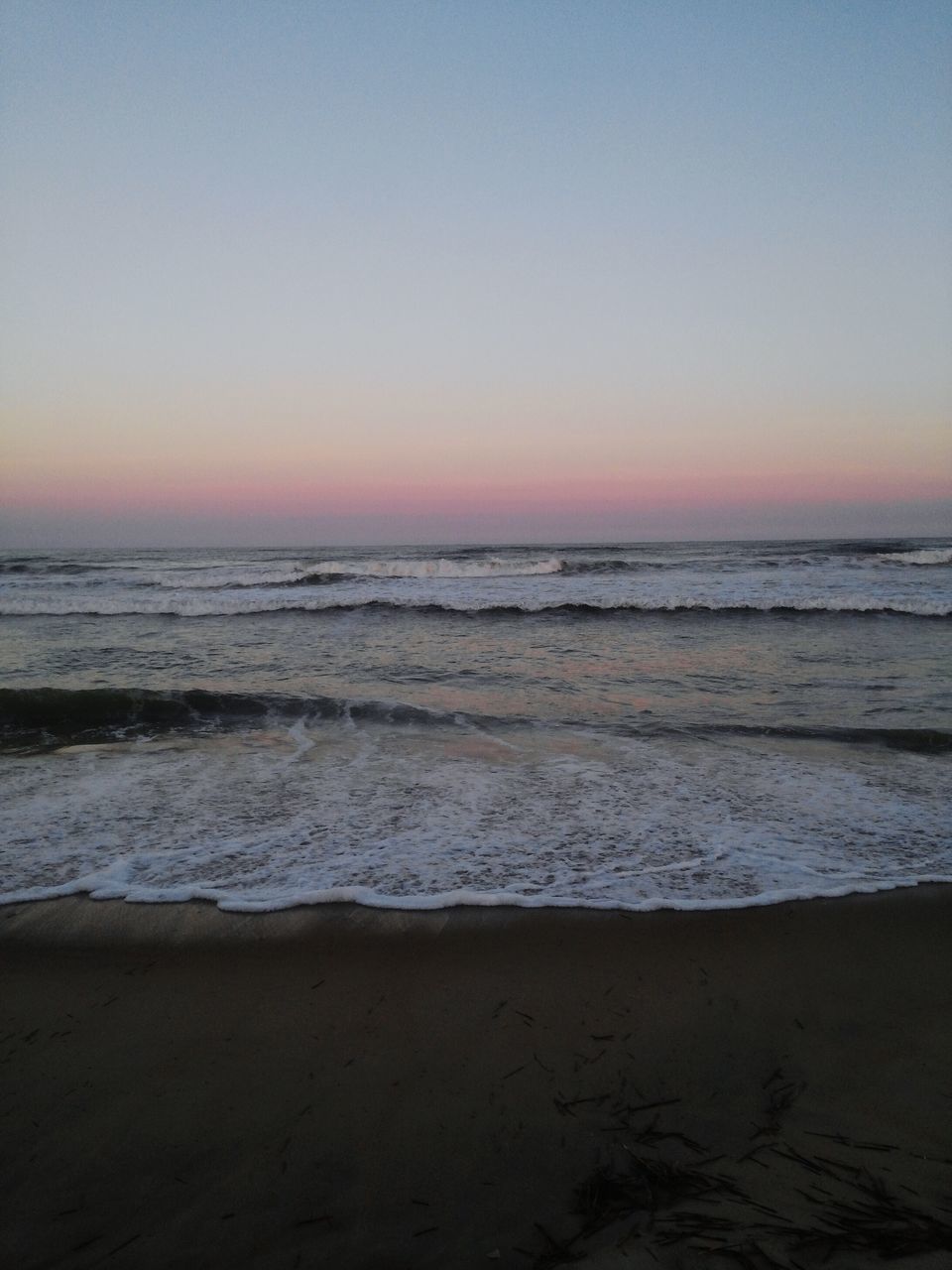 sea, horizon over water, beach, water, shore, scenics, tranquil scene, tranquility, sunset, beauty in nature, sand, clear sky, wave, copy space, nature, idyllic, coastline, surf, sky, remote