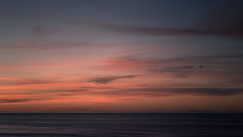 Scenic view of sea against sky at sunset