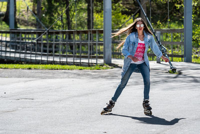 Full length of young woman on skateboard