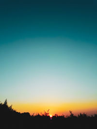 Scenic view of silhouette landscape against clear sky at sunset