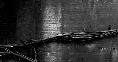 Close-up of rope on brick wall