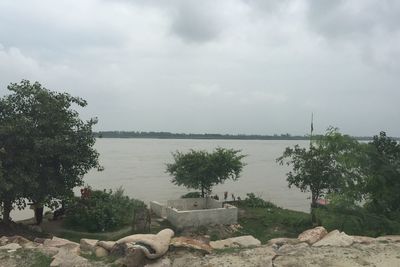 Scenic view of lake against cloudy sky