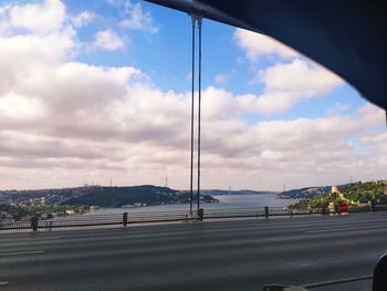 Road by bridge against sky in city