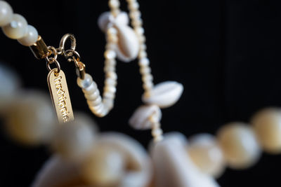 Close-up of necklace over black background