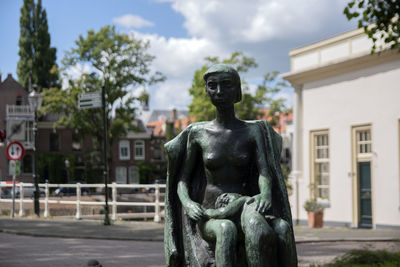 Statue against building in city