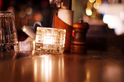 Close-up of illuminated lamp on table