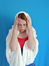 Midsection of young woman against white background