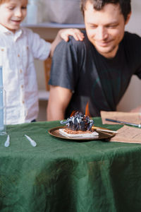 High angle view of boy looking at table