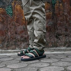 Low section of man standing on street