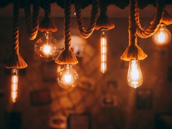 Illuminated light bulbs hanging indoors