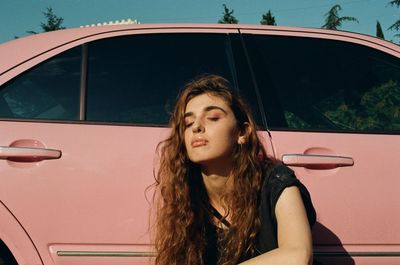 Portrait of beautiful woman sitting in car