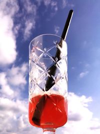 Low angle view of wine glass against sky