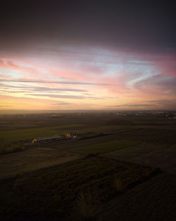 Scenic view of field against sky during sunset