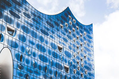 Low angle view of modern building against blue sky