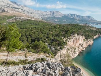 Scenic view of sea and mountains against sky