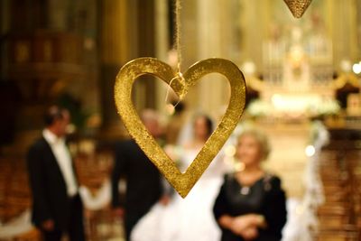 Hear shape decoration with wedding couple in background in church