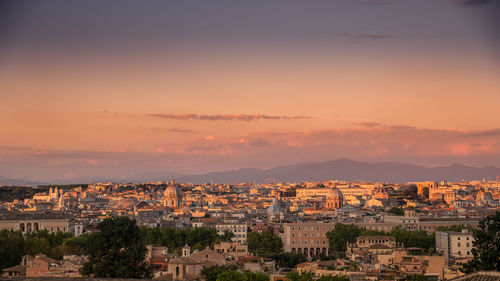 High angle shot of townscape against sky at sunset