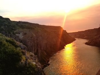 Scenic view of rock formation against sky during sunset