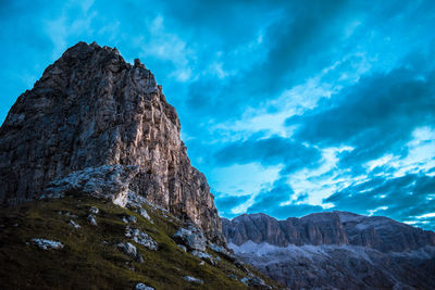 Low angle view of mountain against cloudy sky