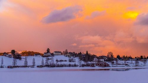 Scenic view of snow covered landscape at sunset