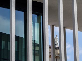 Low angle view of reflection on glass window of building