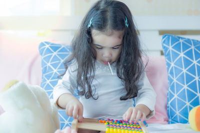 Cute girl with toy on table