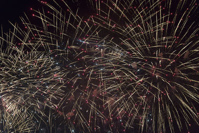 Low angle view of firework display at night