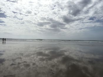 Scenic view of sea against cloudy sky