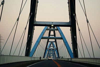 Low angle view of suspension bridge against sky